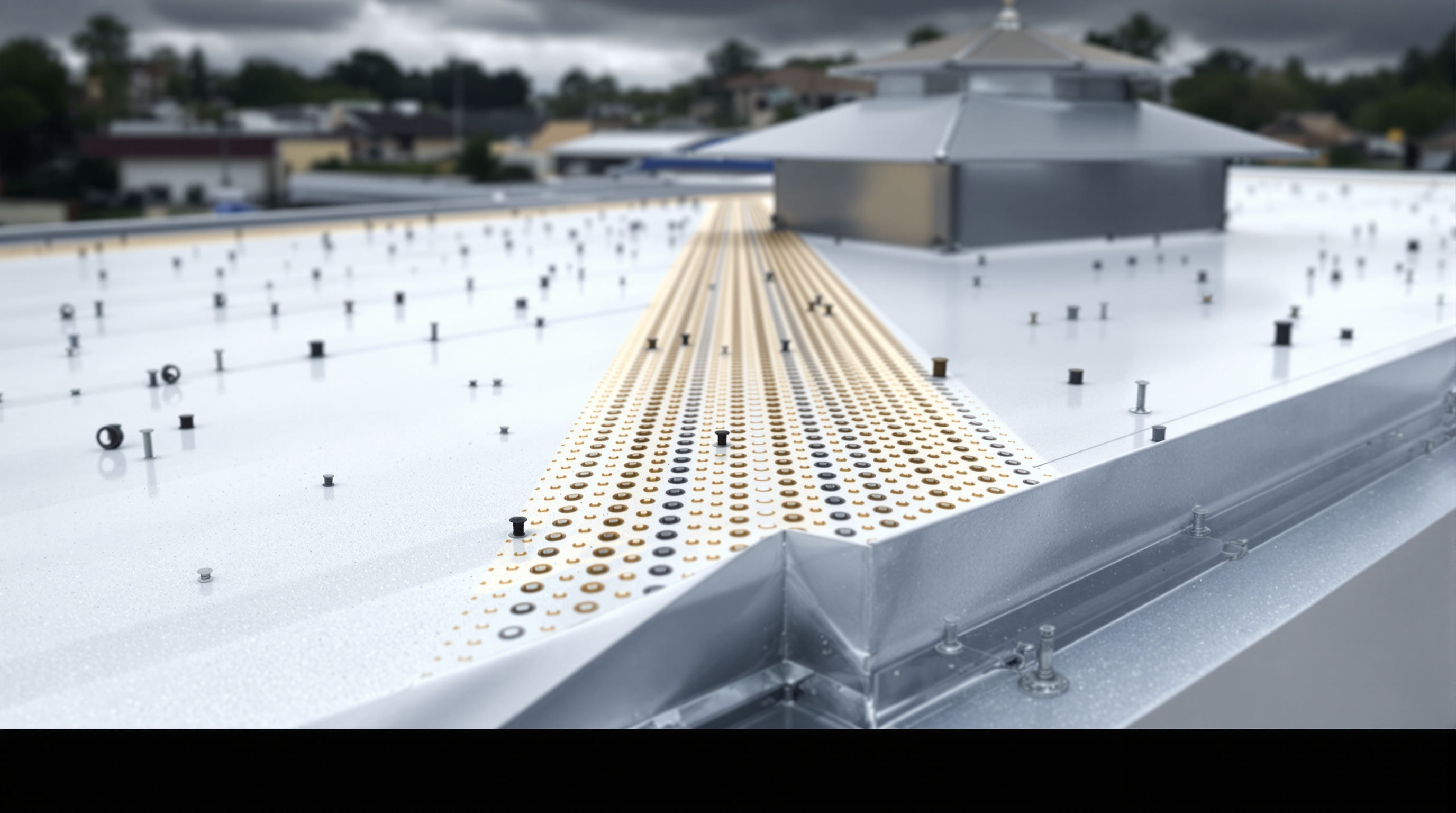 Commercial roofing contractor mechanically fastening polyisocyanurate insulation board to a steel deck on a low-slope commercial building in Baldwin County Alabama, with fastener density calculated per ASCE 7-16 Wind Zone III requirements for 140 to 160 mph design wind speeds and FM Global compliance across the Gulf Coast market